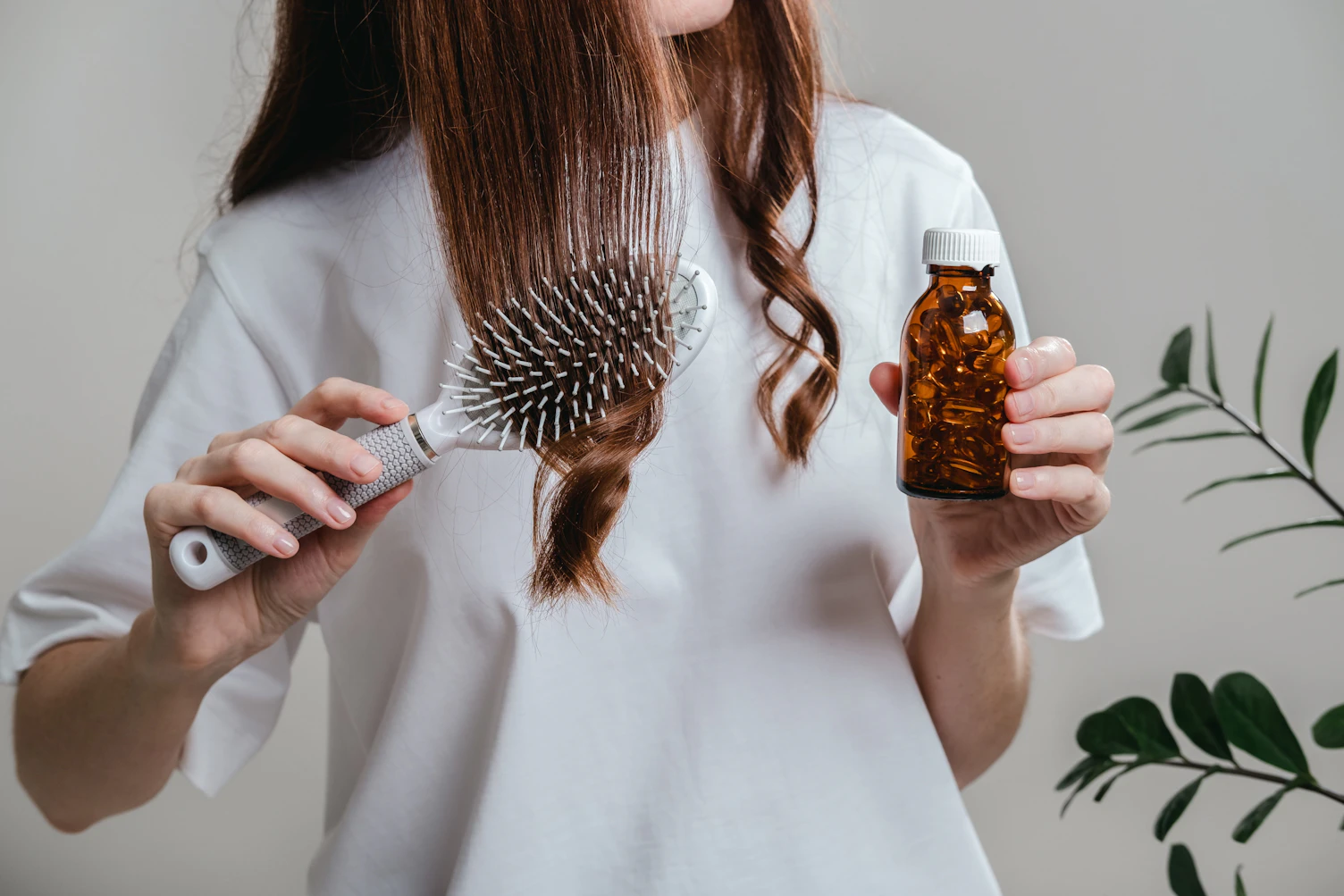 A woman holds omega 3 fish oil capsules