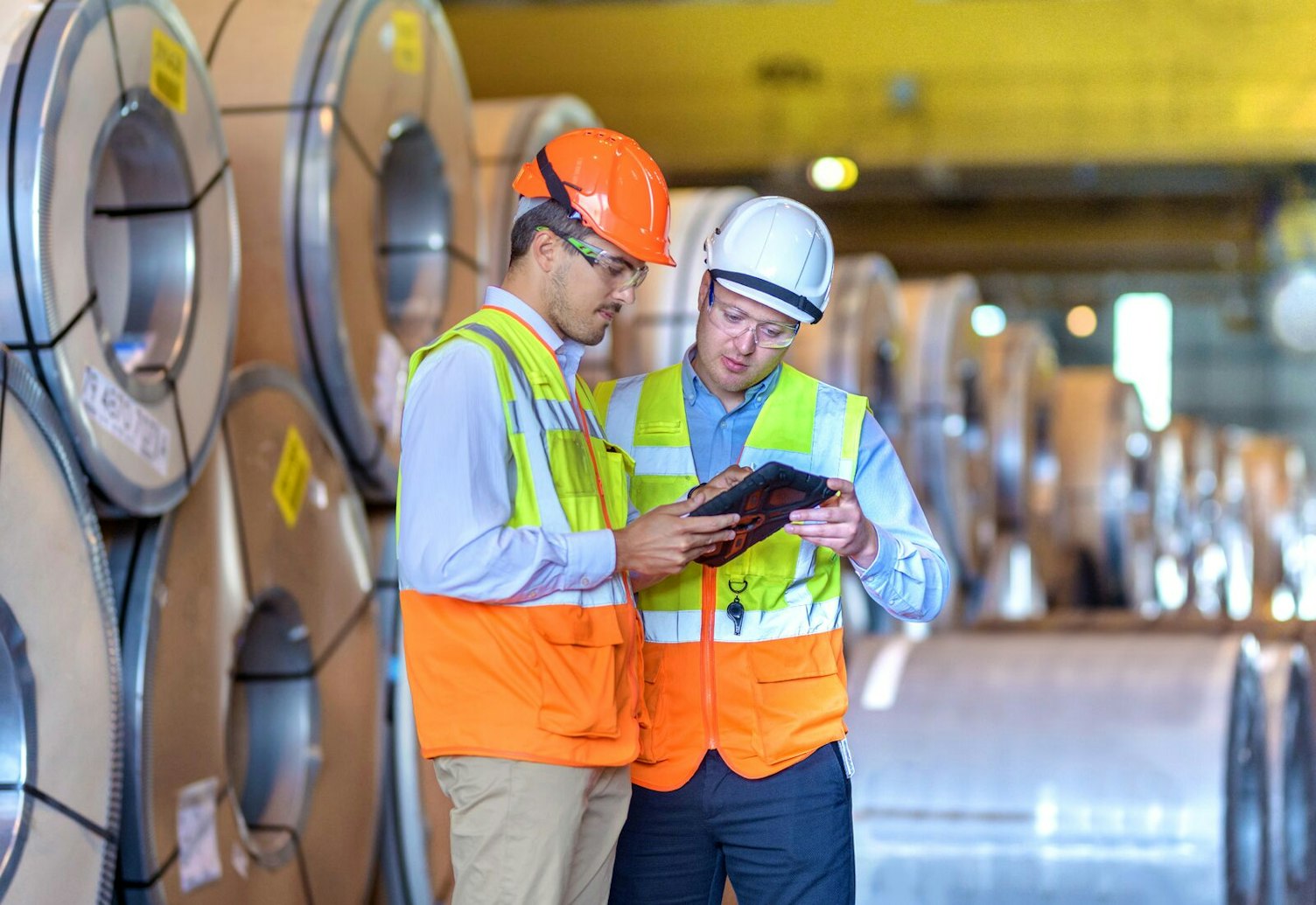 Inspector Using Digital Tablet at Steel Sheet Factory
