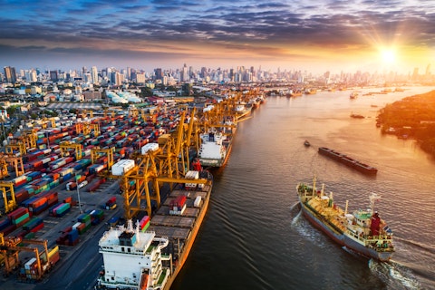 Container ship in import export and business logistic, By crane, Trade Port, Shipping cargo to harbor, Aerial view from drone, International transportation, Business logistics concept.