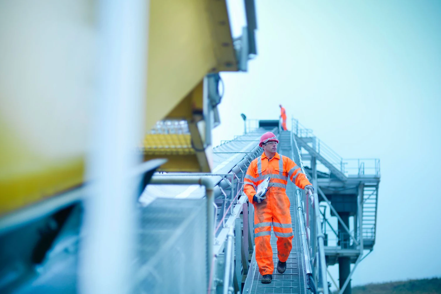 Worker Climbing Screening Conveyor