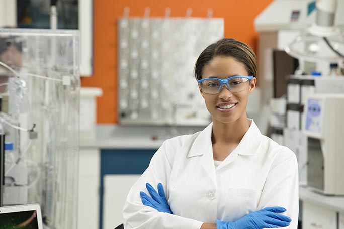main feature female scientist working in lab looking happy