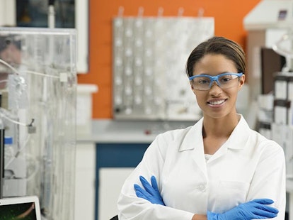 main feature female scientist working in lab looking happy