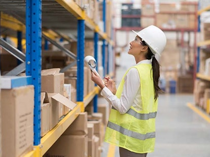 Lady checking stock in warehouse
