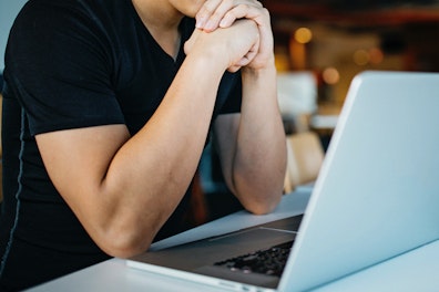 main feature man in front of computer