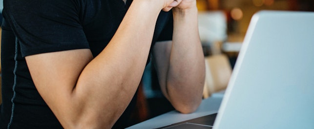 main feature man in front of computer