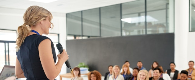 main feature businesswoman delivering a presentation at a conference