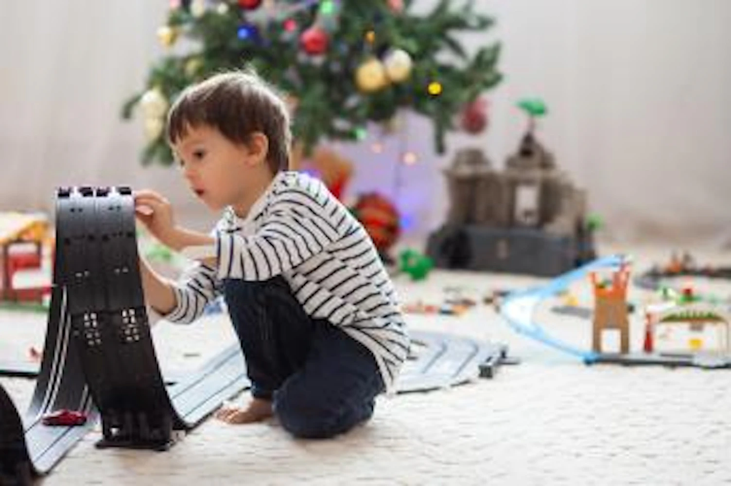 main feature kid playing with Christmas toys Getty572461065