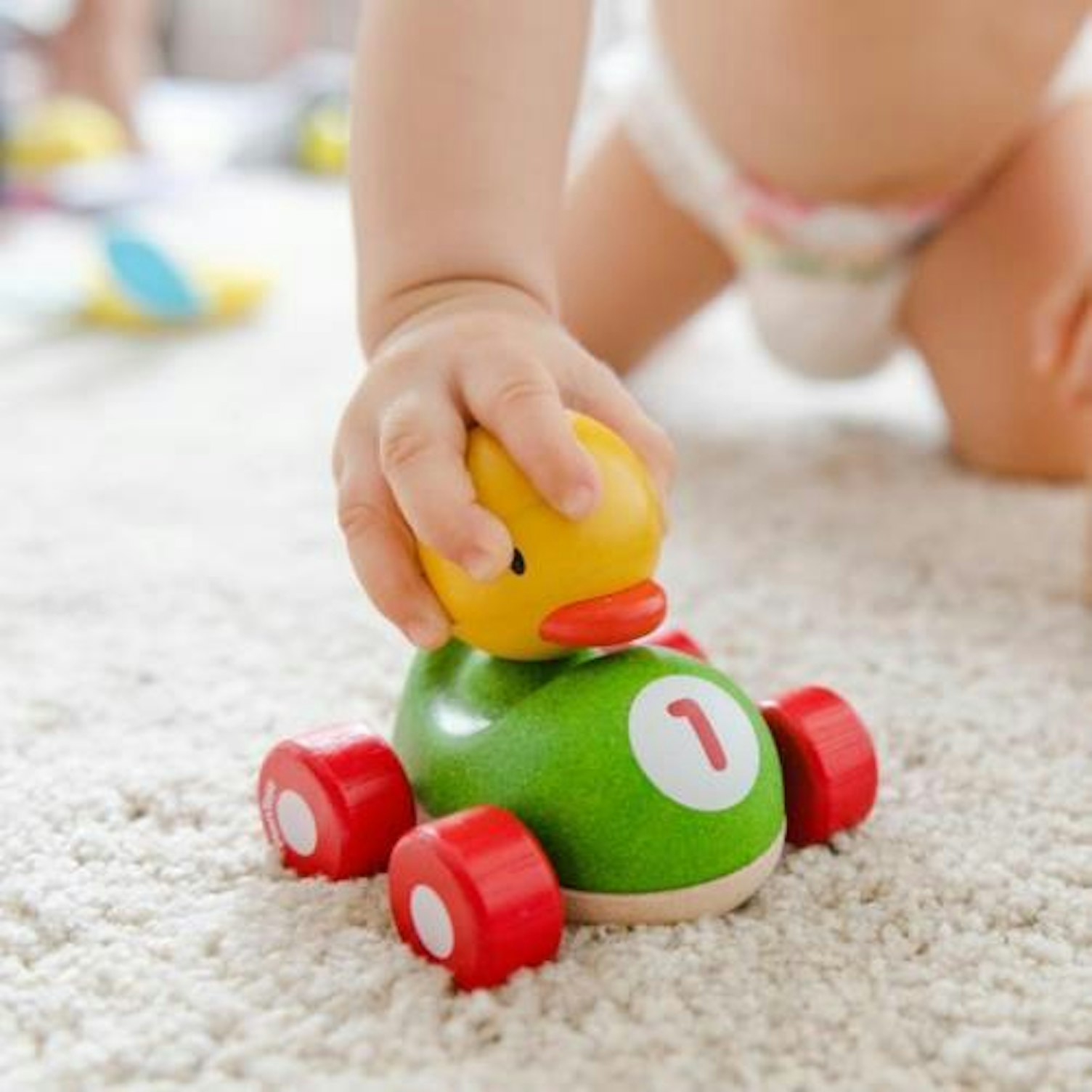 orig baby playing with wooden car Pexels1776137