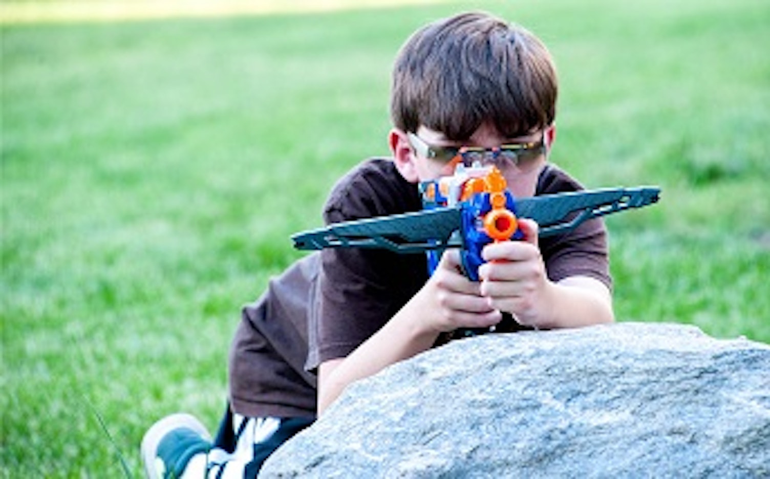 orig boy in sunglasses holding toy gun