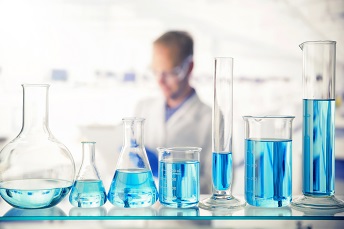 orig close up of various solutions in beakers on shelf