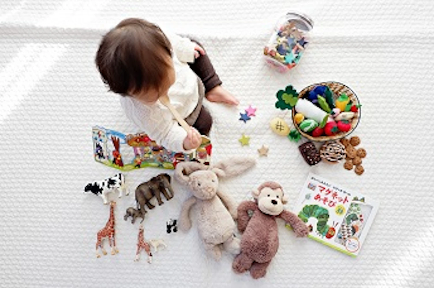 orig kid sitting with toys 344
