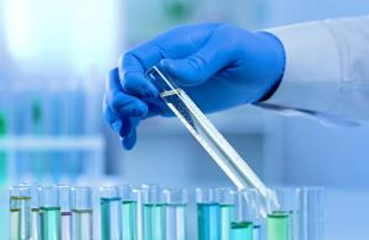 orig lab worker taking test tube watching changes in substance scientific experiment Getty1081762450
