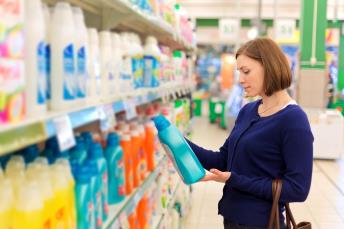 orig lady buying detergent in supermarket Getty507840170