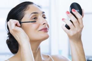 Mature Woman Applying Mascara Make Up