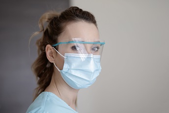 orig medical staff wearing safety visor and protective mask