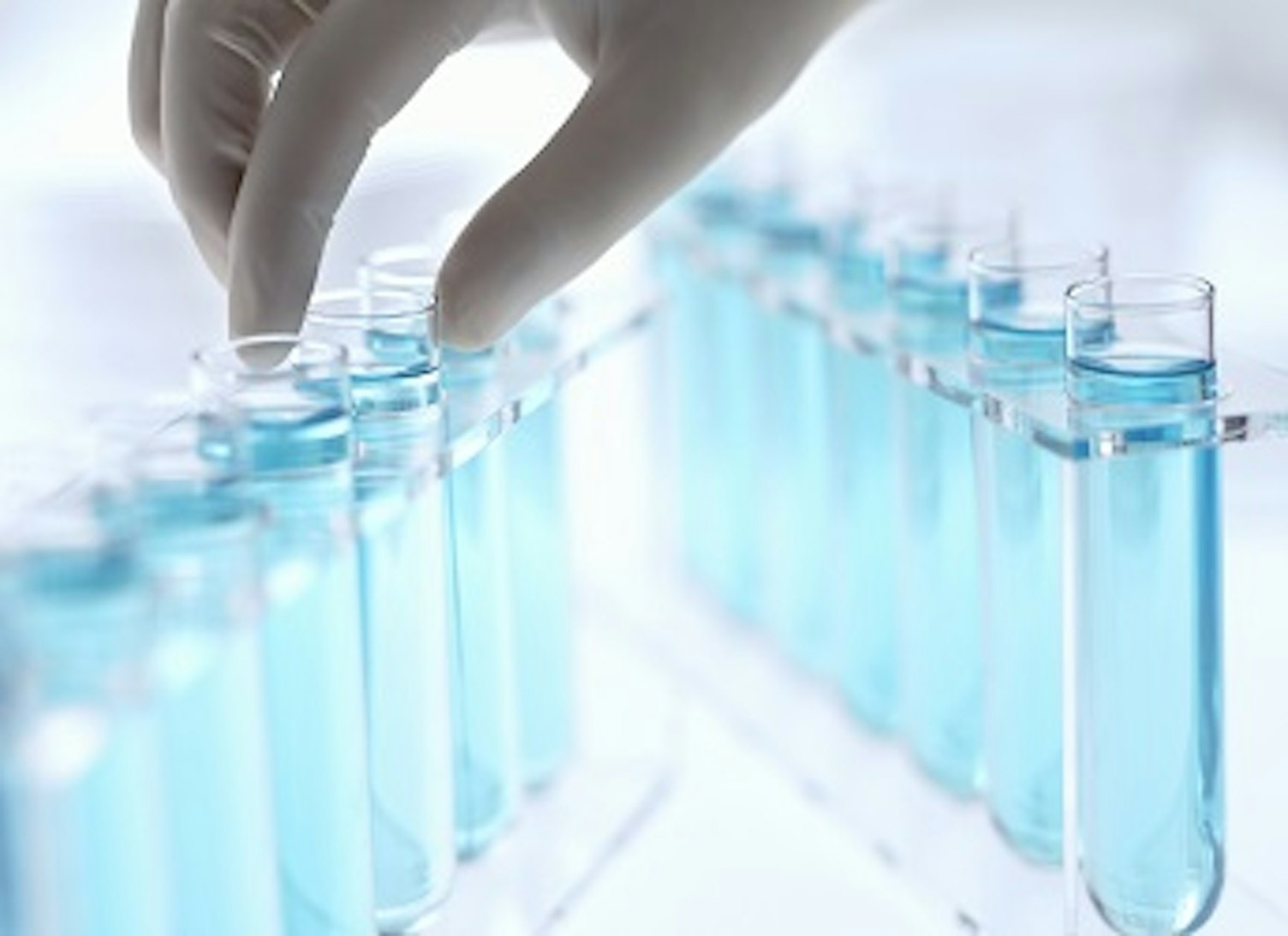 orig scientist reaching for test tubes