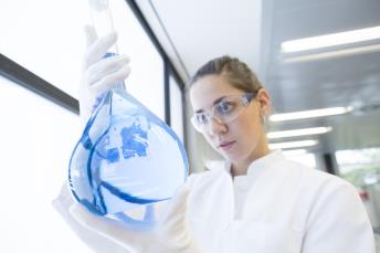 orig scientist with glass bulb in a chemical lab Getty542509525