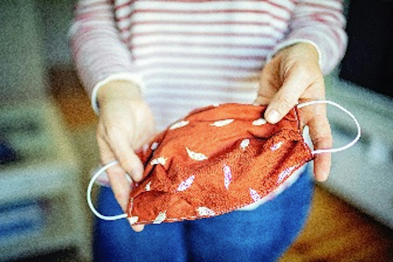 web_orig woman shows selfmade mask to protect against virus and bacteria Getty1215224067