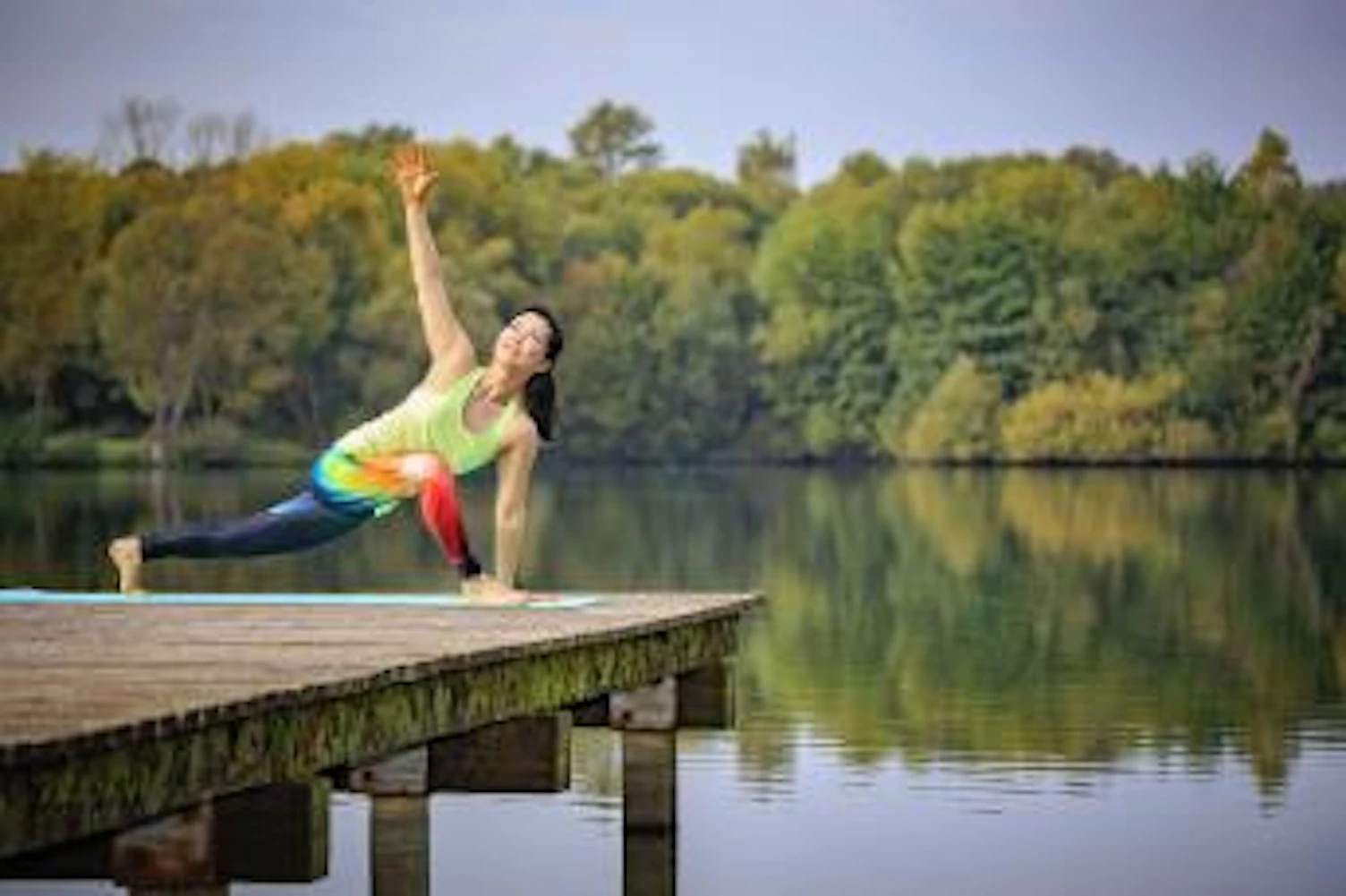 Woman Practising Yoga on Jetty near Lake