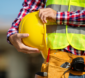 Orig Worker Holding Helmet Getty618948626 Copy