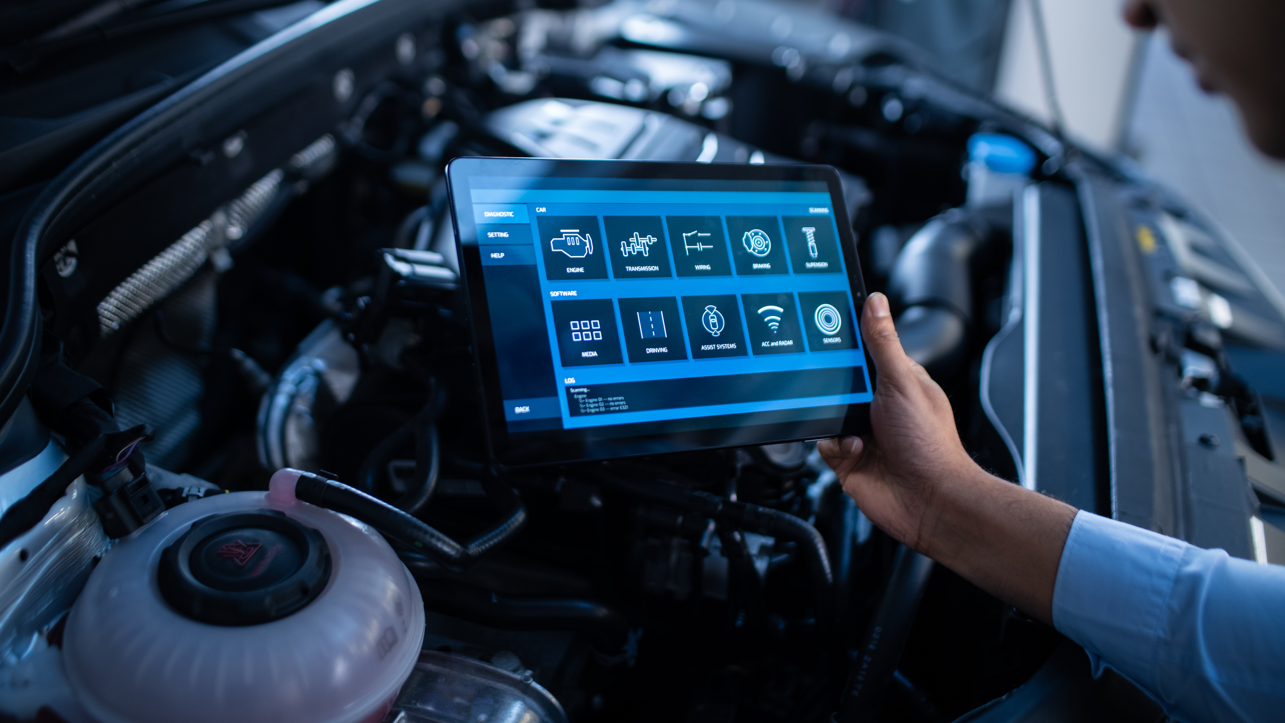 Mechanic Using a Tablet Computer with a Futuristic Interactive Diagnostics Software