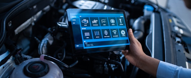 Mechanic Using a Tablet Computer with a Futuristic Interactive Diagnostics Software