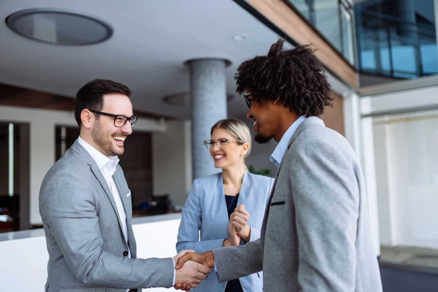 People in suits standing having a business discussion