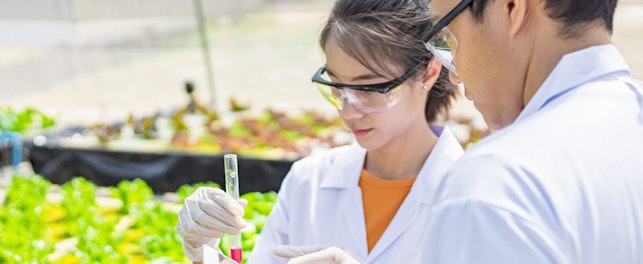 Agricultural Scientists Working in Greenhouse