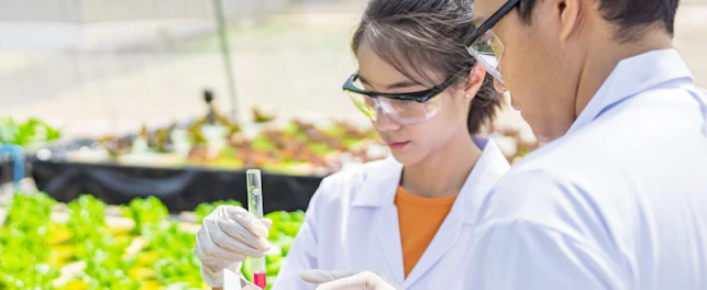 Agricultural Scientists Working in Greenhouse
