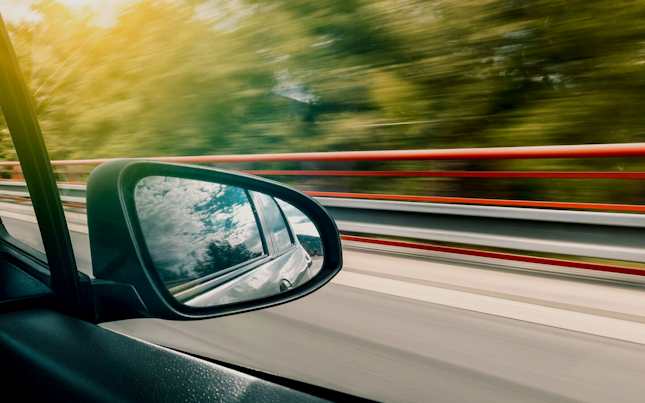 Car in motion from mirror view