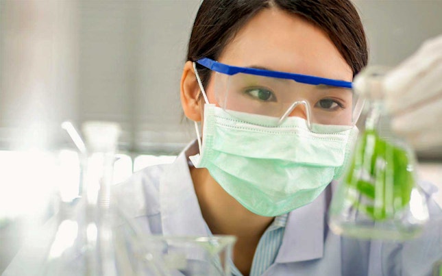 Chemist checking solution