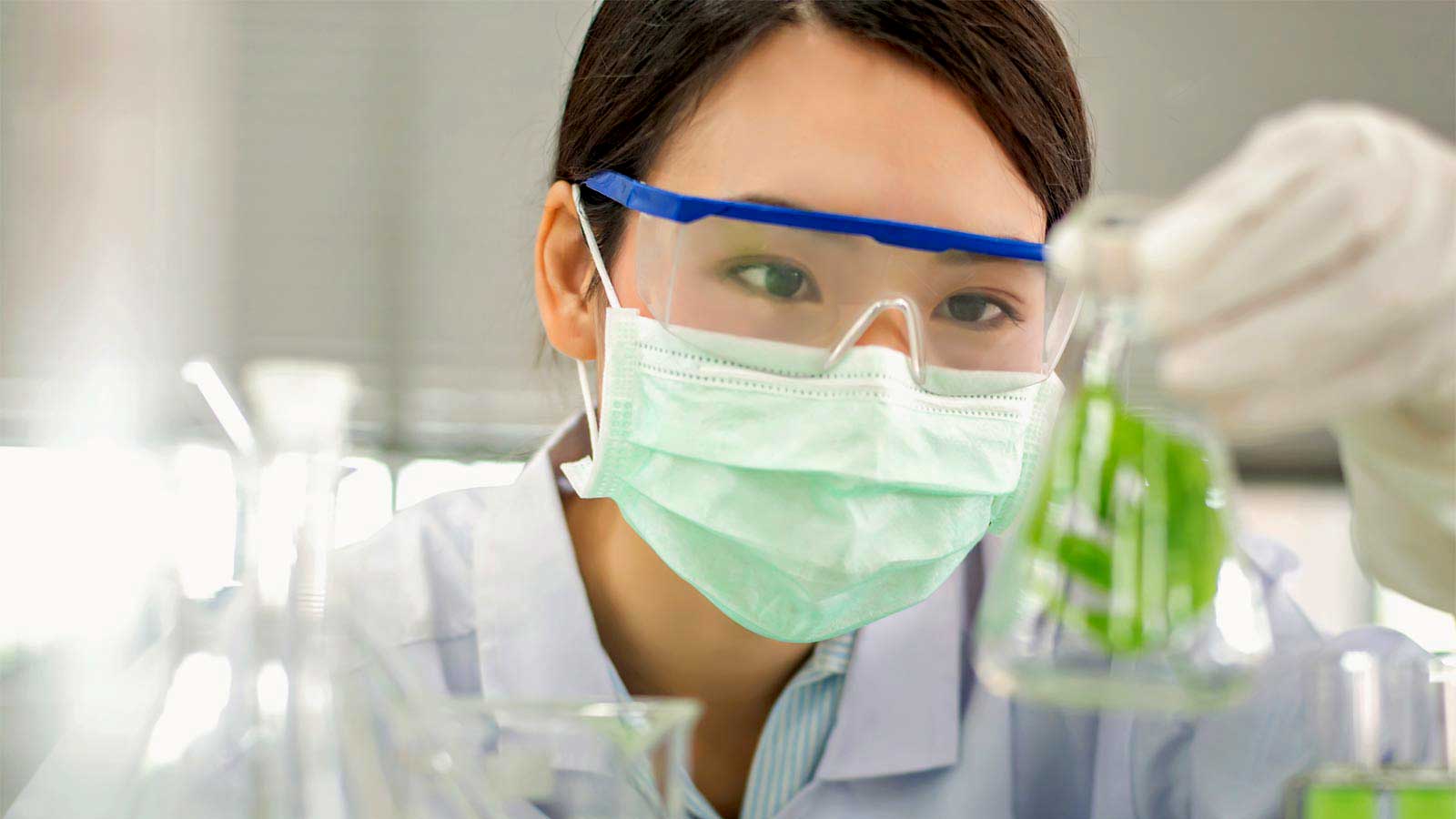 Chemist checking solution