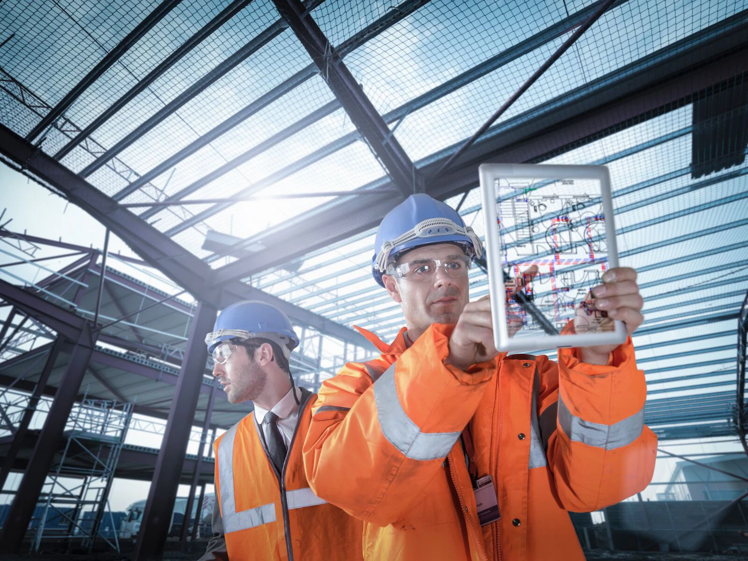Construction Engineers Working on Plan Details Using Digital Tablet
