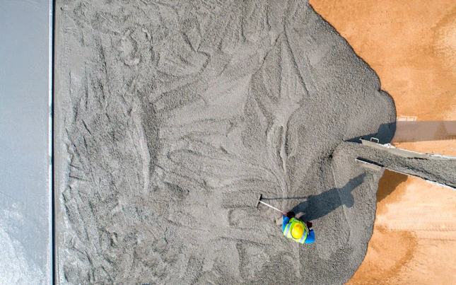 Construction Worker Pouring Wet Concret