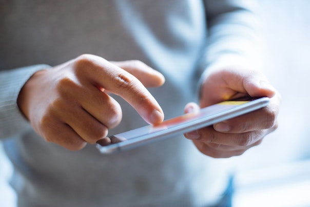 Man Holding External Battery and Smartphone 