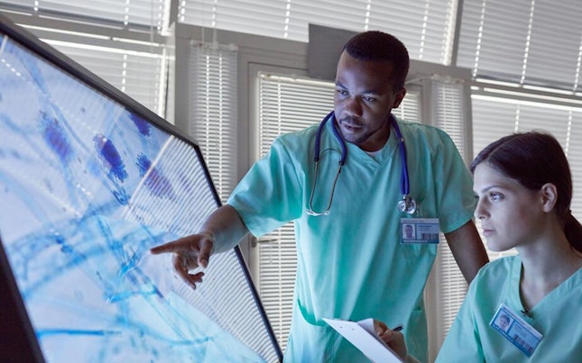 Doctors checking microorganism on big screen