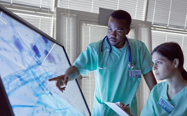 Doctors checking microorganism on big screen