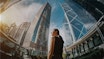 Fisheye effect of woman facing buildings 