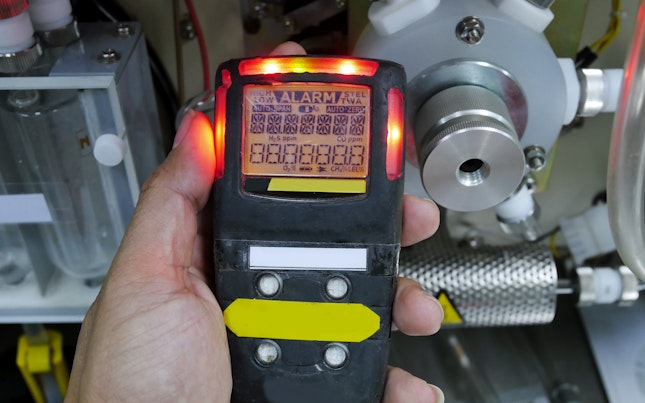 Man Holding External Battery and Smartphone