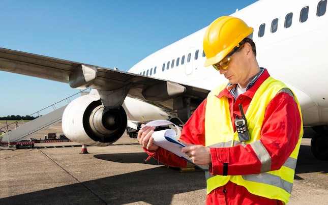 Handling Agent Checking Aircraft Paperwork