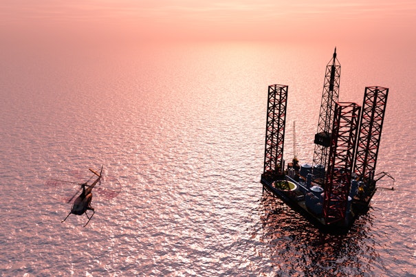 Helicopter Flying over Offshore Oil Rig