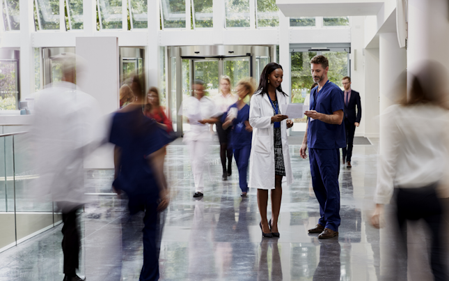Doctor and nurse chatting in the hospital lobby