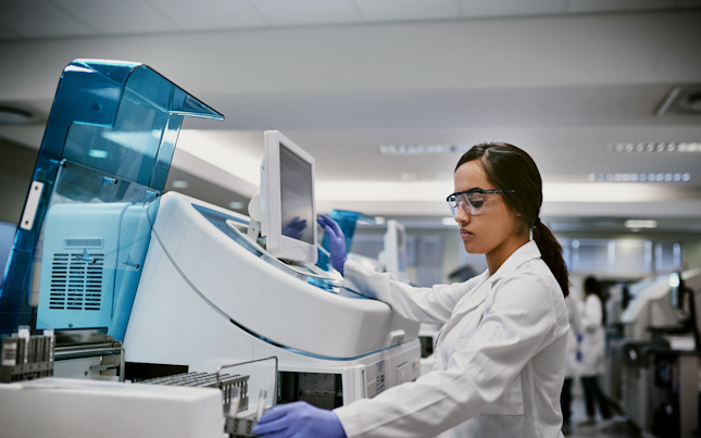 Hero Female Using Machinery in a Laboratory