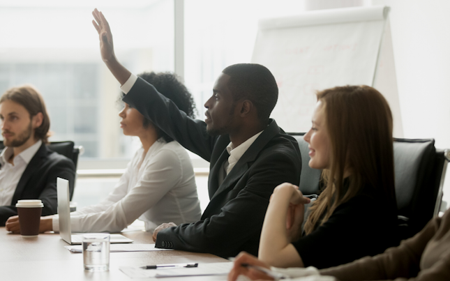 Male raising hand in a training