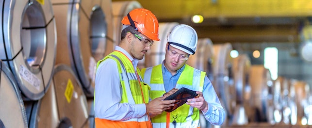 Inspector Using Digital Tablet at Steel Sheet Factory