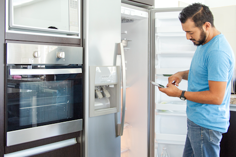 Man Standing Infront of an Open Fridge