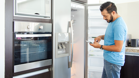 Man Standing Infront of an Open Fridge