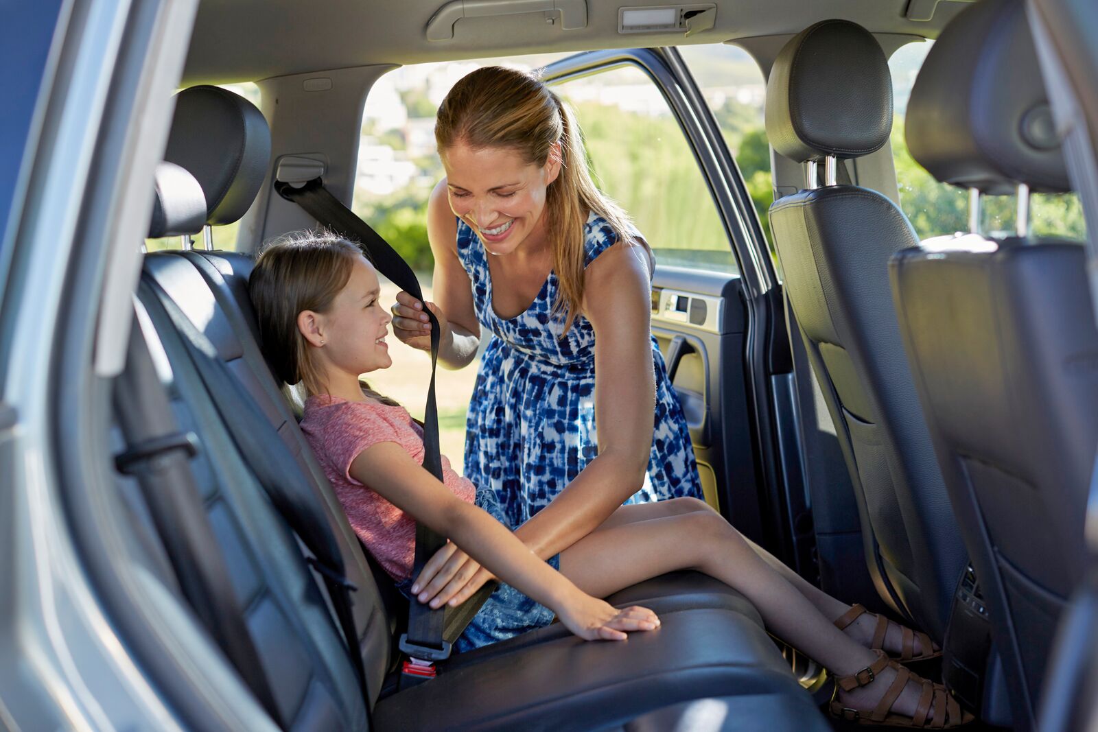 Woman Fastening her Seatbelt in her Car before Driving