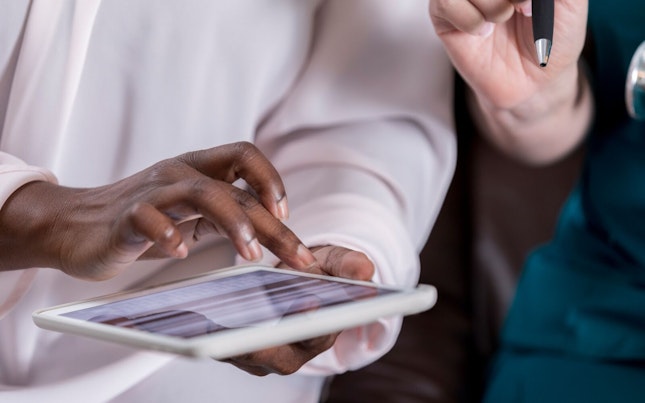 Patient Completing Medical Information on Digital Tablet