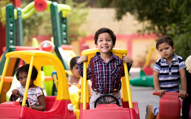 Preschool Kids Playing on Toy Car